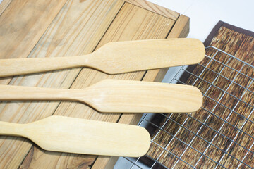 Cooking spatulas made from wood are arranged neatly in the kitchen. Ready to cook next time
