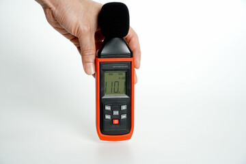 Pollution is too loud.hand holding a digital sound level on a white background,Sound level meters...