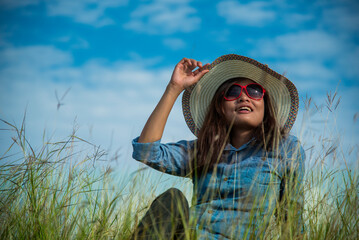 Portrait Asian Woman relaxing in green park. Happy Relax asian woman smiling face at outdoors...