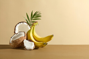 The brown color flatform featuring some coconut pieces and a bunch of banana piled up on the left...