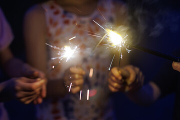 Holding and Lighting sparkler fireworks at night, sparks shooting