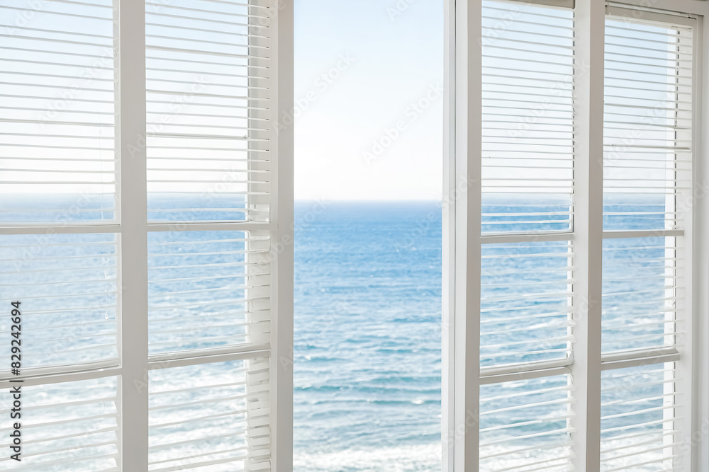 Wall mural white window shutters with ocean view