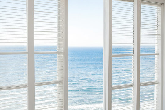 Fototapeta White window shutters with ocean view