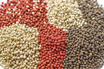 Fototapeta premium Close up of four different types of peppercorns