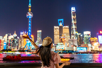 Young female tourist relaxing and looking beautiful modern city at Shanghai, China