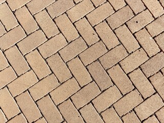 Overhead view of a brick pattern driveway and walkway path, featuring intricate designs and a...
