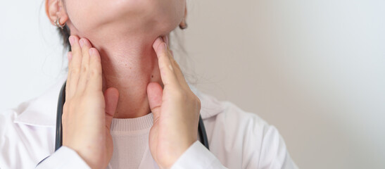 Woman checking Thyroid gland disease. Hand holding Neck pain. Hyperthyroidism, Hypothyroidism,...