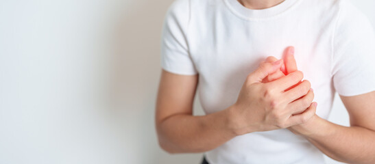 Woman hand holding chest ache. Heart disease, angina disease and symptom heart attack disease Cardiovascular, Atherosclerosis, Hypertensive, Breast Cancer awareness, world Heart day and health concept