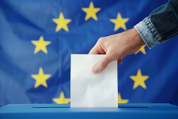A person is putting a white piece of paper into a box. The box is next to a blue and yellow flag. 
European elections.