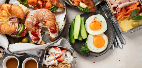Large selection of breakfast food on a table.
