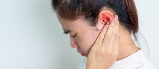 Woman holding her painful Ear. Ear disease, Atresia, Otitis Media, Inflation, Pertorated Eardrum,...