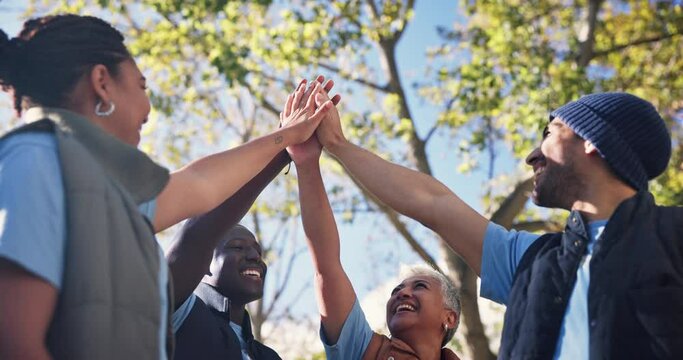 People, volunteers and high five in outdoor for success of community service or program, collaboration and teamwork. Diversity, unity and together to celebrate for development, social justice and ngo