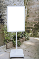 Mockup of the blank white street city outdoor advertising vertical poster sign stand on restaurant...