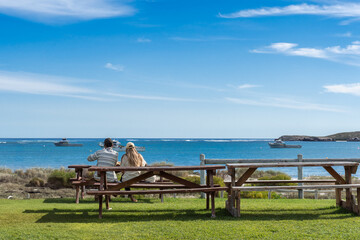 Tourist couple enjoying lunch with an ocean view in Lancelin, Western Australia