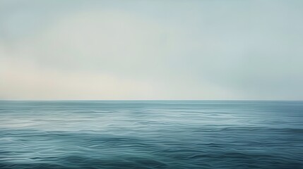 Fototapeta premium Escape to tranquility with this serene image of a hazy ocean horizon, where the sky meets the sea.