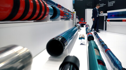 New bright polished metal pipes at the store. Media. Metal and plastic pipes are lying around for...