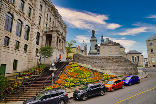 The Saint Francois de Laval Monument with the background of the Basilica Notre Dame as seen from the Montmorency Park in Quebec city, the capital of Quebec province,Canada