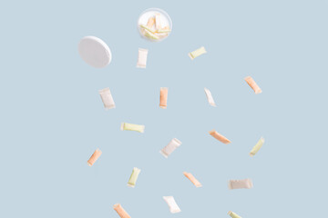 Different sachets of non-smoking tobacco product with different flavors are poured out of a plastic...