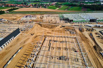 Aerial view of construction site with warehouse building under construction for storage. Assembling...