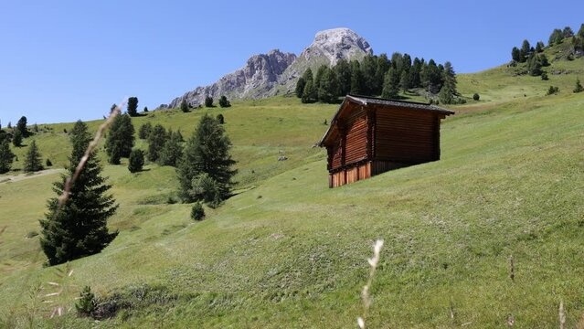 Rare houses and outbuildings on hillsides near Goma mountain pass, Dolomites
