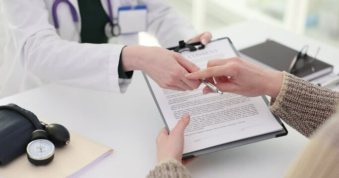 Doctor and patient discuss medical consent form