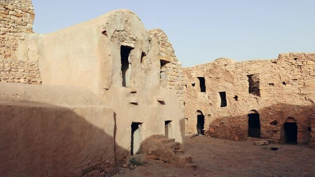Ruins of ancient abandoned Berber granary structures in Ksar Daghar in Tunisia, standing as testament to traditional North African architecture