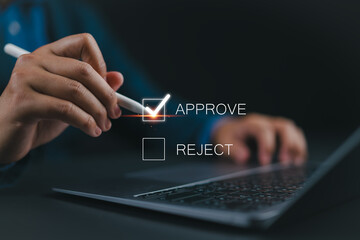 Businessman putting a valid check mark in the check box to approve documents and project ideas