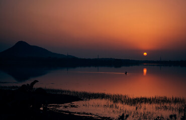 majestic evening view at Baranti lake (a popular travel spot in Purulia), with holden hued last rays of setting sun creating a magical backdrop. 