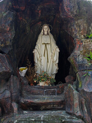 View of the statue of the Virgin Mary in an artificial grotto.