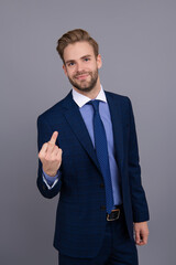 Rude businessman show middle finger. Businessman in suit shows an indecent gesture isolated on...