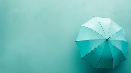Top-down view of a teal umbrella, pastel background, perfect for text overlay, close-up shot