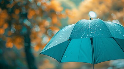 Teal umbrella in focus, soft blurred background, designed with space for text, aerial shot