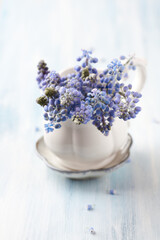 Purple flowers on bright wooden background. Close up. Copy space.