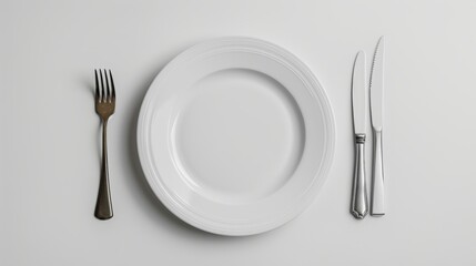 Simple top view of a clean white plate, perfectly aligned with a fork and knife on a white table, highlighted against a spotless white background