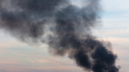 Black smoke from a fire against the sky