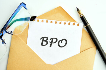 Text BPO Business Process Outsourcing an inscription on a piece of paper peeking out of an envelope...