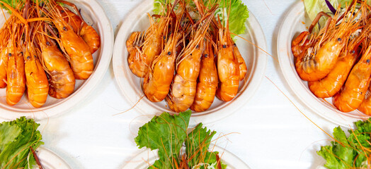 Red boiled crayfish in white plates as a background