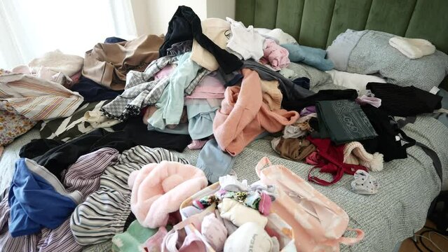 messy bed with cloths in early morning , messy bed after waking up 