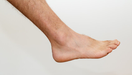 Outer side of male foot on plain white background. Graphic resource of anatomy and structure of the...