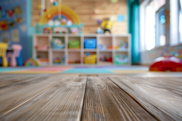 Fototapeta premium A wooden play table in the foreground with a blurred background of a children's playroom. The background includes colorful toys, bookshelves with children's books, soft play mats, and cheerful.