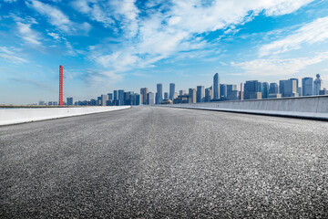 Empty asphalt road and modern city skyline background in Hangzhou