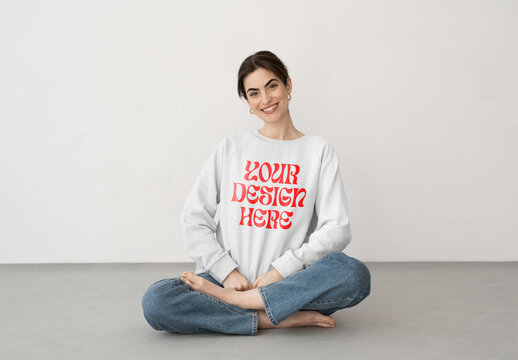 Mockup of woman wearing customizable sweatshirt, cross legged