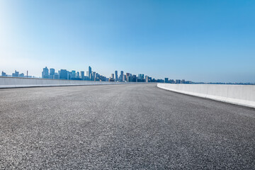 Empty asphalt road and modern city skyline background in Hangzhou