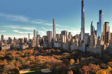 Autumn Central Park with downtown skyscrapers view from drone. Aerial of NY City Manhattan Central Park panorama in Autumn. Autumn in Central Park. Autumn NYC. Central Park Fall foliage.