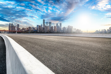 Empty asphalt road and modern city skyline background in Chongqing