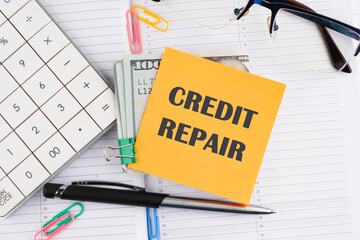 Business, finance and fix your credit here concept. Concept words CREDIT REPAIR on a yellow sticker...