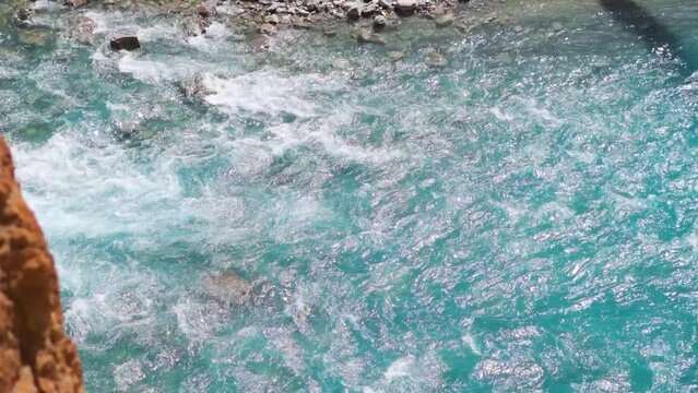 Closeup shot of blue colored Tsarap Chu river flowing in the remote areas of Zanskar as seen during the trek to Phugtal Gompa in Zanskar Valley, Ladakh, India. Blue colored river flowing in Himalayas.