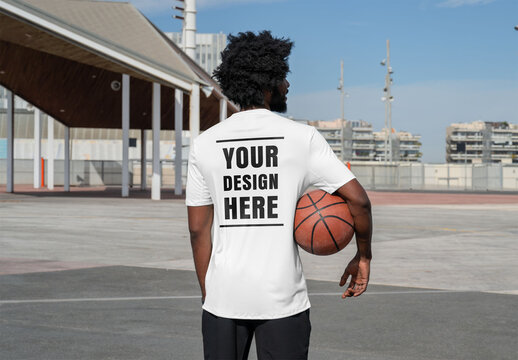 Mockup of man wearing customized t-shirt, basketball under arm