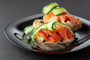 Sandwiches with smoked trout, cream cheese, fresh cucumber, and capers.