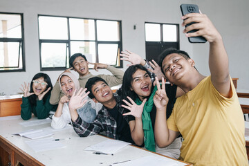 Multiethnic Asian Young Friends Taking Selfie On Smartphone In Classroom At School